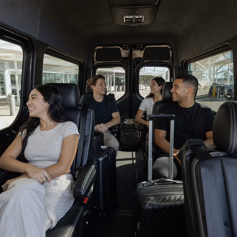 Passengers loading luggage while boarding an New Orleans group shuttle