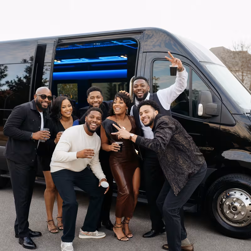 Group boarding a white charter bus for Birthday Transportation transportation in New Orleans