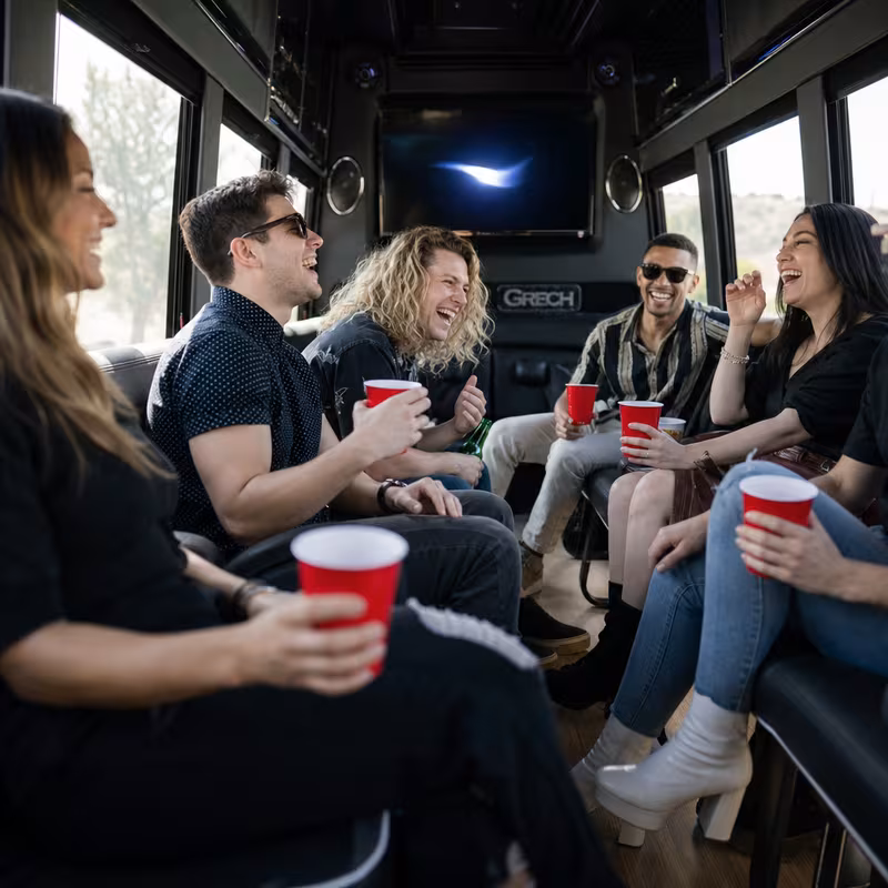 Group boarding a white charter bus for Concert Transportation transportation in New Orleans
