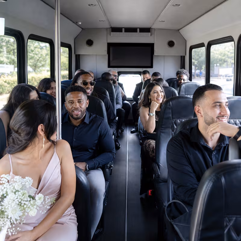Group boarding a white charter bus for Private Event Transportation transportation in New Orleans