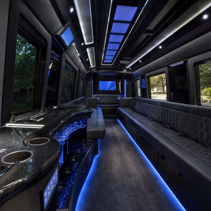 Party bus interior with wraparound leather seating and LED lighting in New Orleans