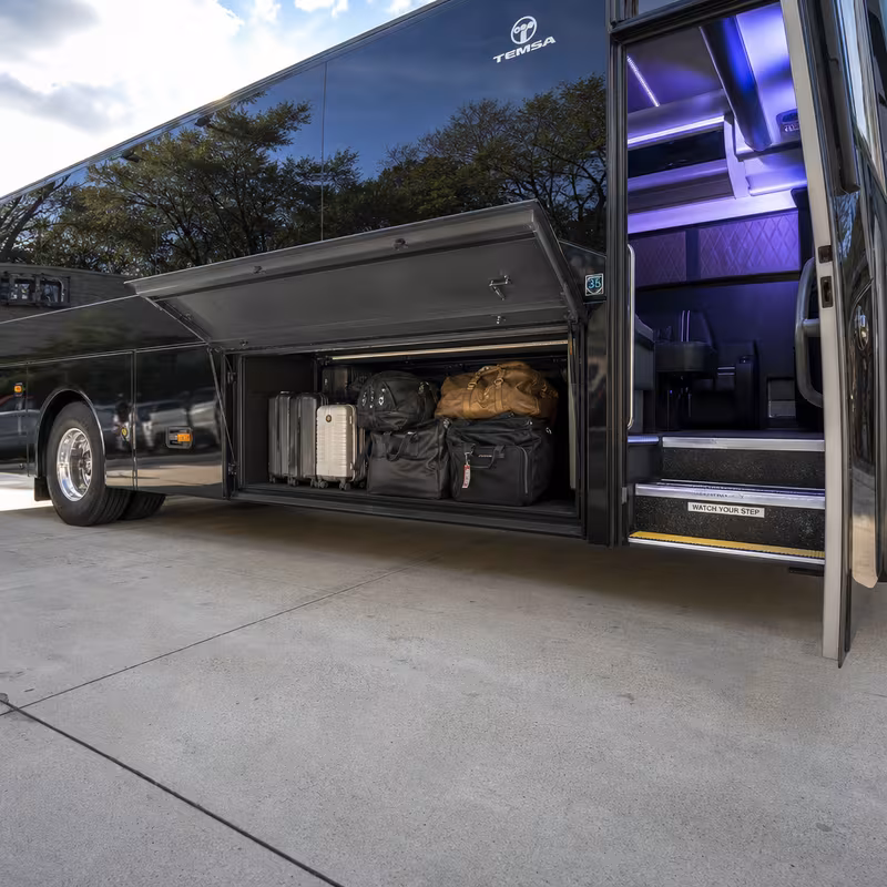 Party bus interior with wraparound leather seating and LED lighting in New Orleans