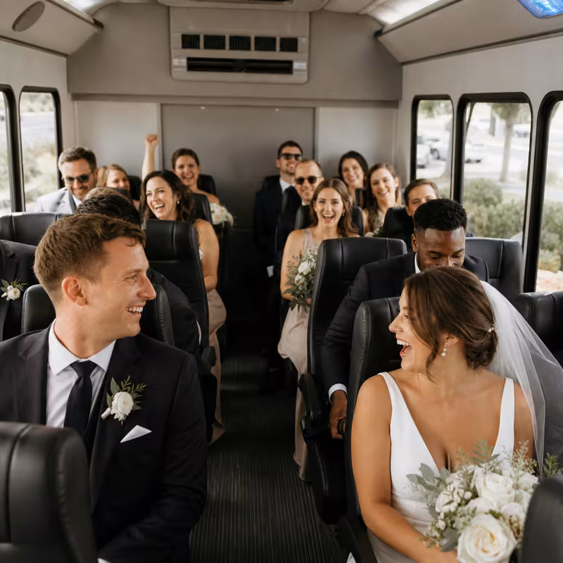 Group boarding a white charter bus for Wedding Transportation transportation in New Orleans
