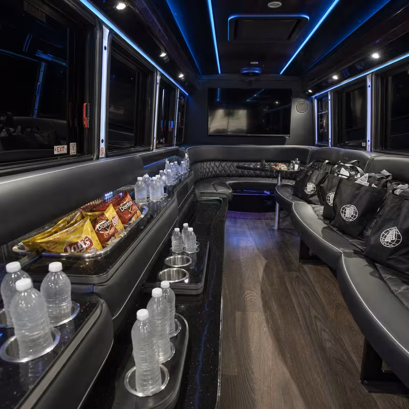 Party bus interior with wraparound leather seating and LED lighting in New Orleans